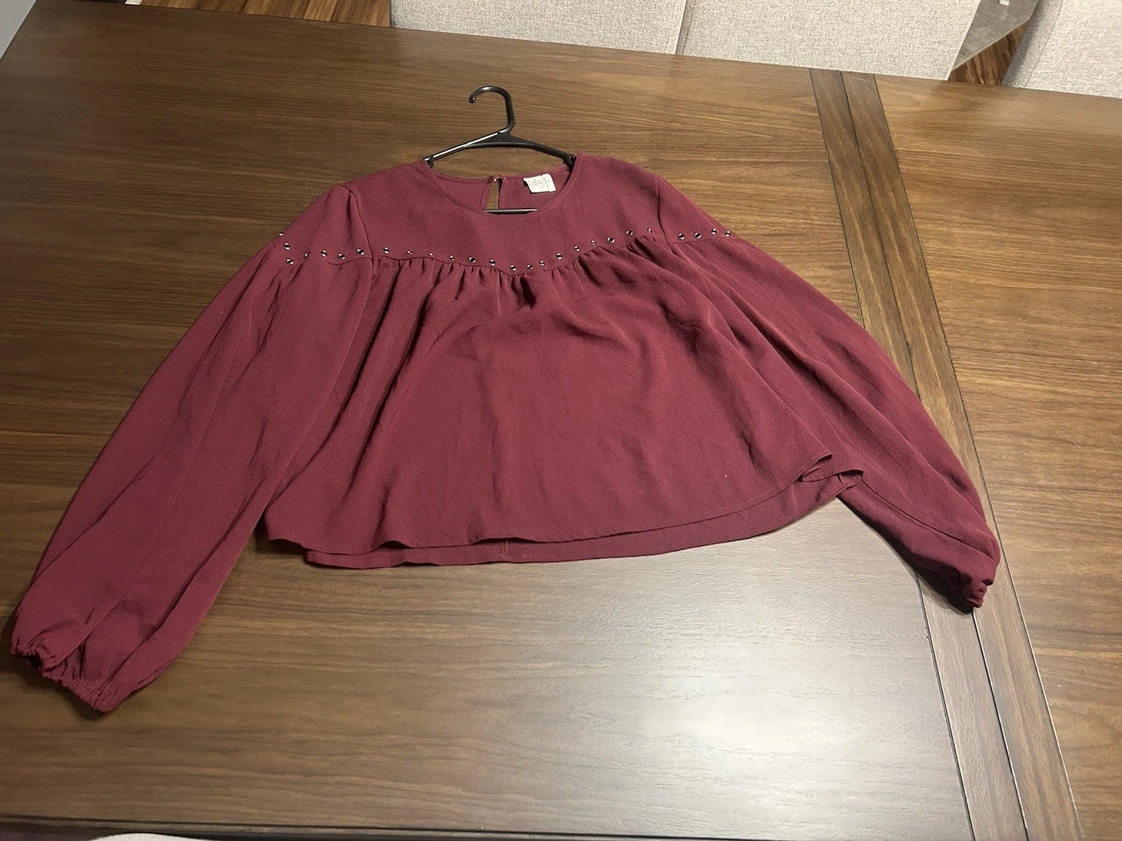 Elegant maroon top with long sleeves. Ideal for any occasion.
